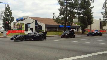the batmobile being chased by a smart car being chased by a lamborghini aventador - meme